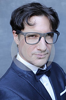 Elegant man wearing suit, bowtie and eyeglasses