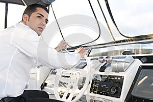 Elegant man at yatch control turnedo