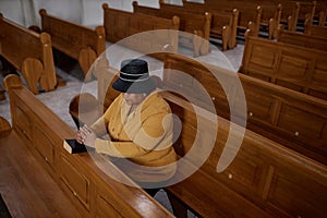 Elegant mature woman praying in church