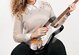 Elegant Melodies: Young Woman Showcasing Her Guitar Skills