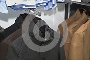 Elegant men clothing in a store,  Suit jacket elegant formal wear, gentleman style , autumn spring Wedding clothes