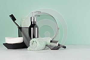 Elegant men dressing table in trend green mint menthe color - black razor, toothbrush, mirror, soap, towel, dispenser.