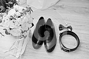 Elegant  men`s wedding shoes, bouquet, belt and tie at groom morning