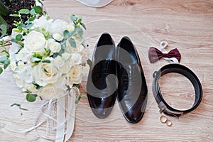 Elegant  men`s wedding shoes, bouquet, belt and tie at groom morning