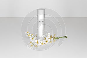Elegant metallic cosmetic bottle without branding on white background.