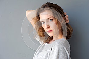 Elegant mid adult woman posing with hand in hair