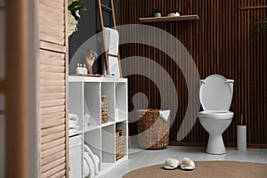 Elegant modern bathroom with toilet bowl near wall