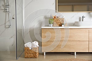 Elegant modern bathroom with wooden cabinet near wall