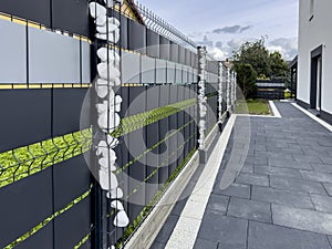 Elegant modern private house fence with ornaments of small white stones