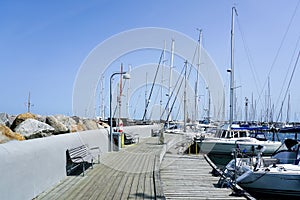 Elegant and modern yacht marina with moored to a pier sailboats and cutters on the coast of Denmark