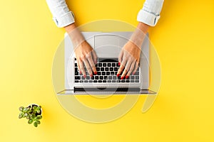 Elegant office desktop with female hands working on laptop. Business workspace