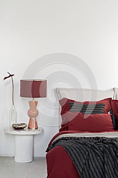 Elegant orange and red lamp on nightstand