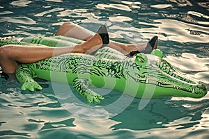 Elegant outfit. Model posing in water wearing black shoes. Female fashion concept