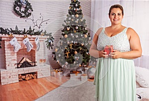 Elegant, overweight woman with Christmas present