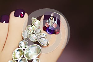 Elegant pedicure with rhinestones. photo