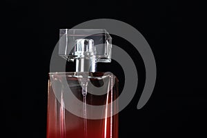 Elegant perfume bottle isolated on black background with copy space