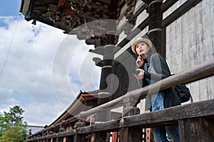 An elegant photographer relying on the handrail