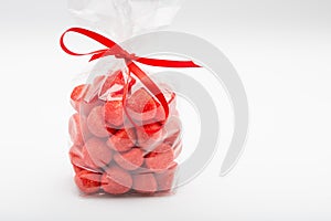 Elegant plastic bag of sugar strawberries with red ribbon