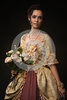 elegant Portet brown-haired woman with a bouquet of roses