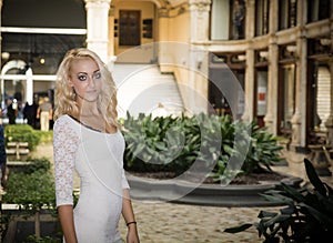 Elegant pretty blonde young woman in posh city setting in Europe photo