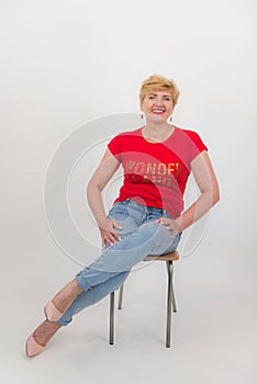 Elegant, pretty middle aged woman photographed on a white background.