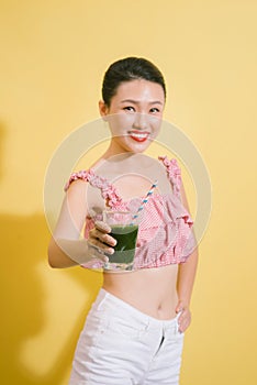 Elegant pretty slim woman drinks green detox.