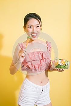 Elegant pretty slim woman eating healthy salad.