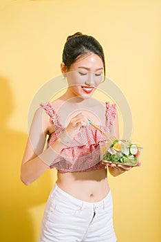 Elegant pretty slim woman eating healthy salad