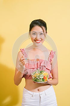 Elegant pretty slim woman eating healthy salad