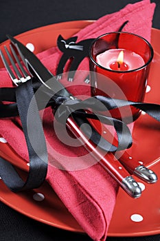 Elegant red and black theme Halloween party dining Table place setting - vertical closeup.