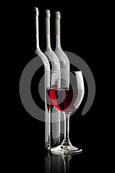 Elegant red wine glass and a wine bottles