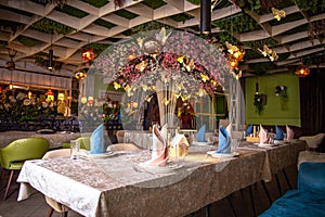 Elegant restaurant interior with decorated ceiling and table settings