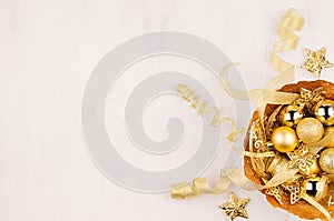 Elegant rich gold christmas home decoration on white wood background.