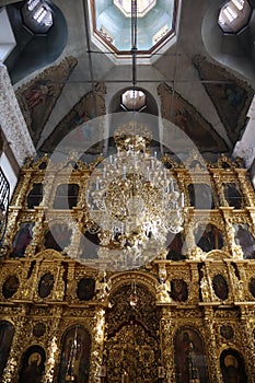 Elegant, rich interior decoration of the Christian church, ceiling paintings, icons, gold frames for icons, carved wood