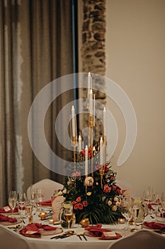 Elegant, romantic table setting for indoor wedding reception. Luxury wedding table decoration, special event table set