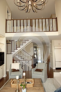 Elegant roomy living room with staircase.