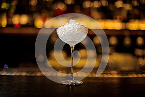 Elegant round cocktail glass filled with a lot of ice