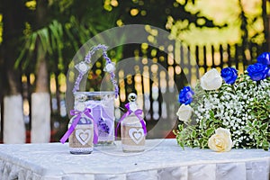 Elegant sand bottles and roses at wedding