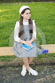 Elegant schoolgirl child girl study with book in park, french student concept