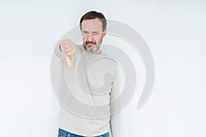 Elegant senior man over isolated background looking unhappy and angry showing rejection and negative with thumbs down gesture