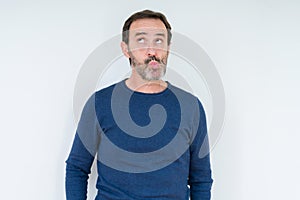 Elegant senior man over isolated background making fish face with lips, crazy and comical gesture