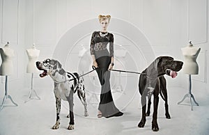 Elegant, serious lady with two giant dogs