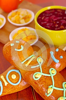 Elegant setup traditional tasty latin american guagua breads, colorful sugar decorations, bowl with colada morada berry