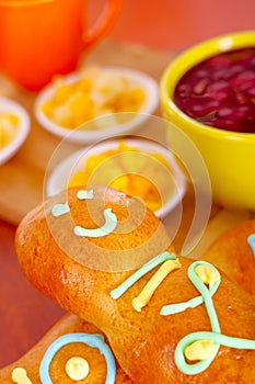 Elegant setup traditional tasty latin american guagua breads, colorful sugar decorations, bowl with colada morada berry