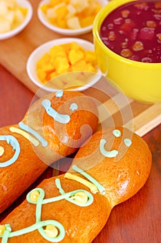 Elegant setup traditional tasty latin american guagua breads, colorful sugar decorations, bowl with colada morada berry