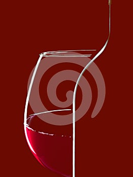 Elegant silhouette bottle of red wine and glass on black background