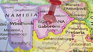 A Elegant Slide Animation of Push Pin Pointing Geographic Area Gaborone on World Map