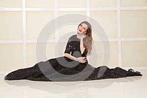 Elegant slim adult woman in fashion long evening lace black dress on white studio background, full length body