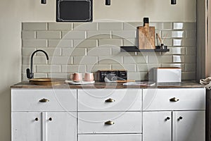 Elegant small kitchen with sink and counter at country house.