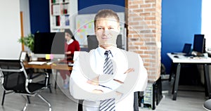 Elegant smiling businessman portrait against modern office background
